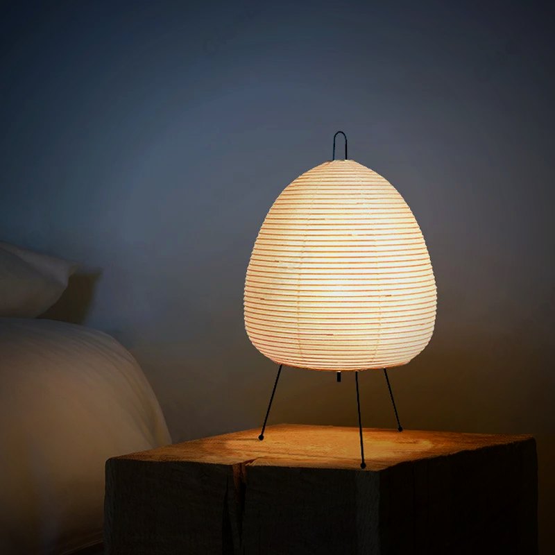Ember Yumi paper lantern lamp beside a bed