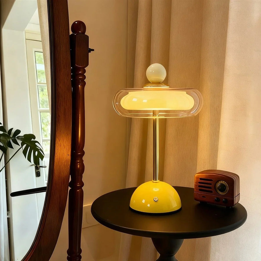 Yellow Sorrel glass lamp beside a mirror and vintage radio
