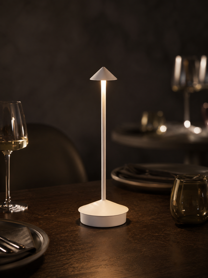Ember Aura cordless lamp glowing on a dark oak dining table