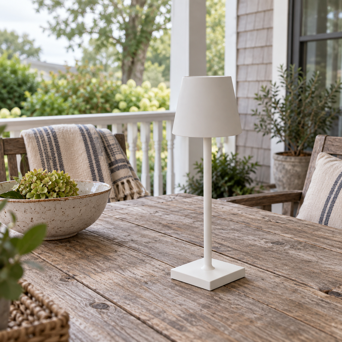 White Marin cordless lamp on a bright covered home porch