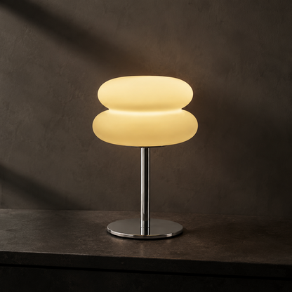 Ember Halo frosted table lamp on dark stone at dusk