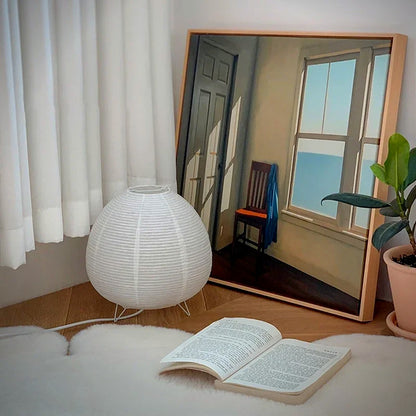 Kana Japanese paper lantern table lamp lit beside a chair