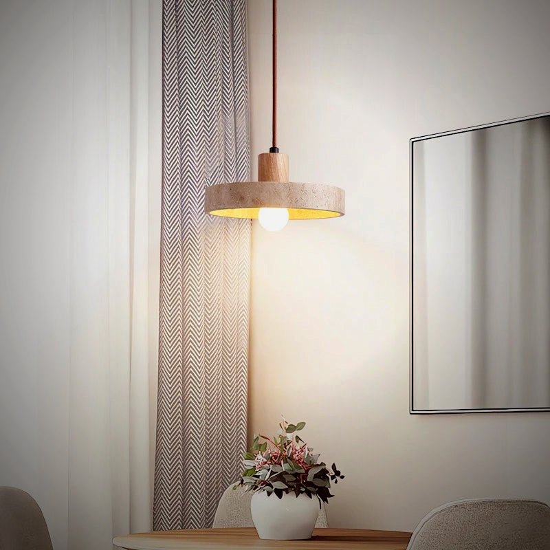 Tora travertine disc pendant over a dining table