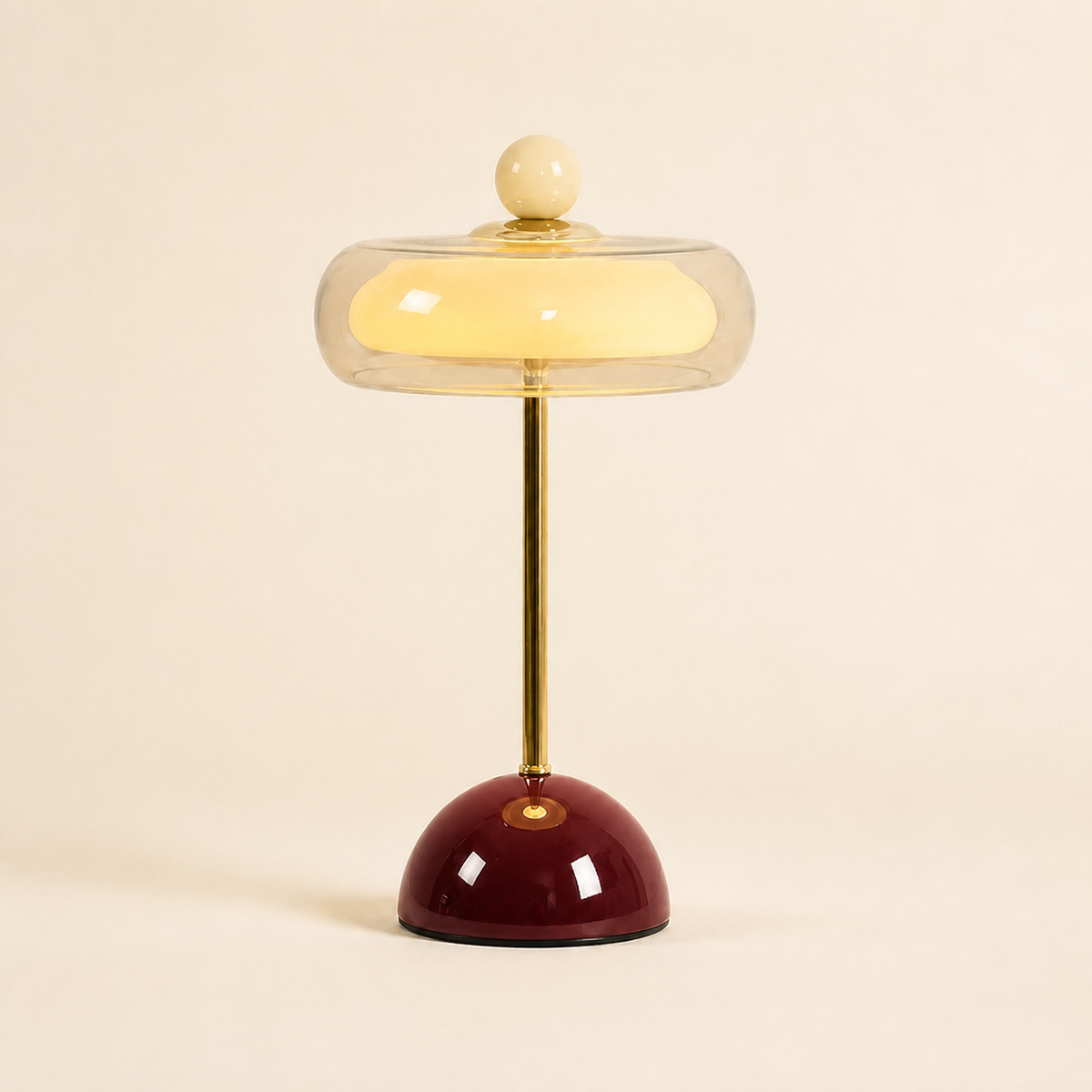 Burgundy Oria rechargeable glass table lamp with a clear dome shade