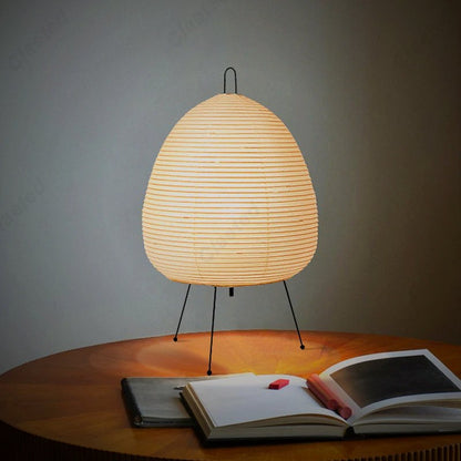 Ember Yumi paper lantern lamp on a table with an open book